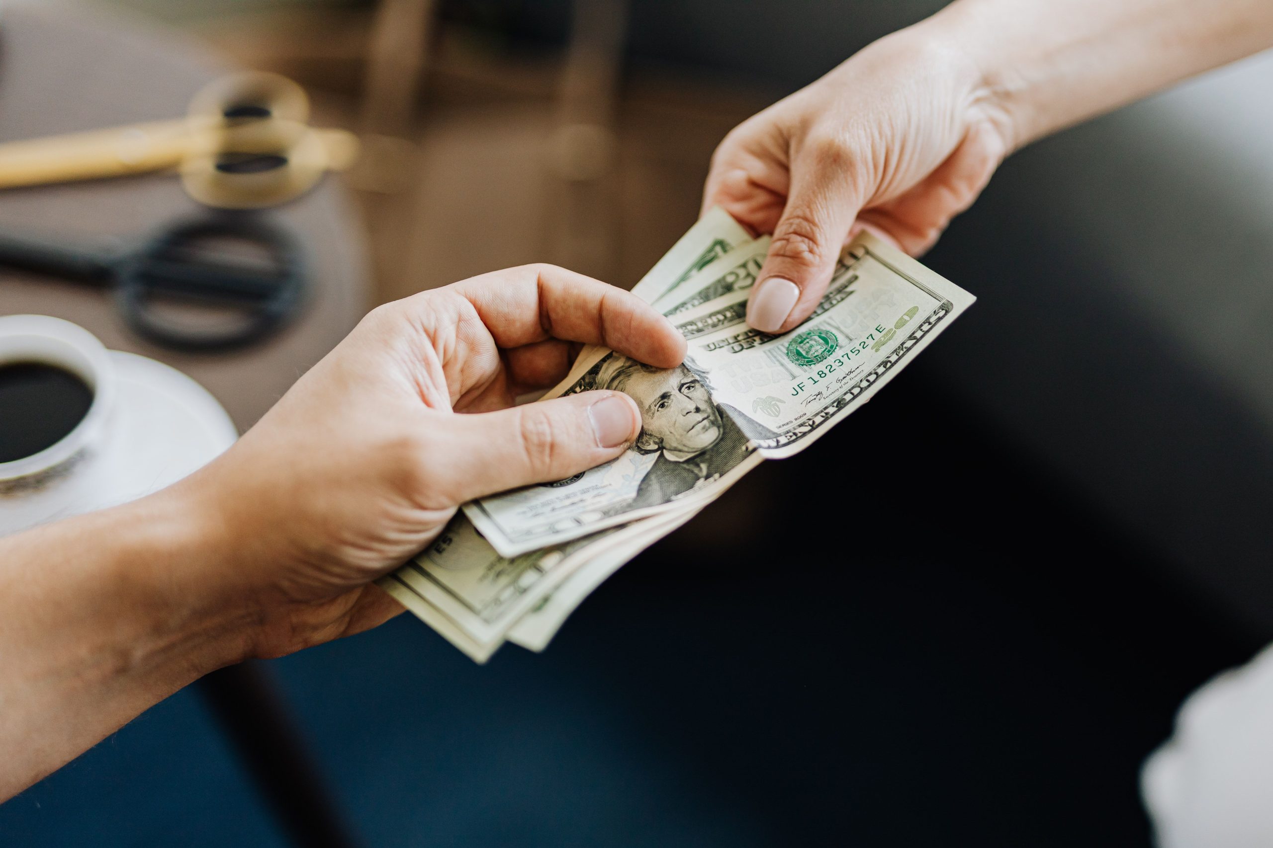 Mains échangeant des billets de dollars américains